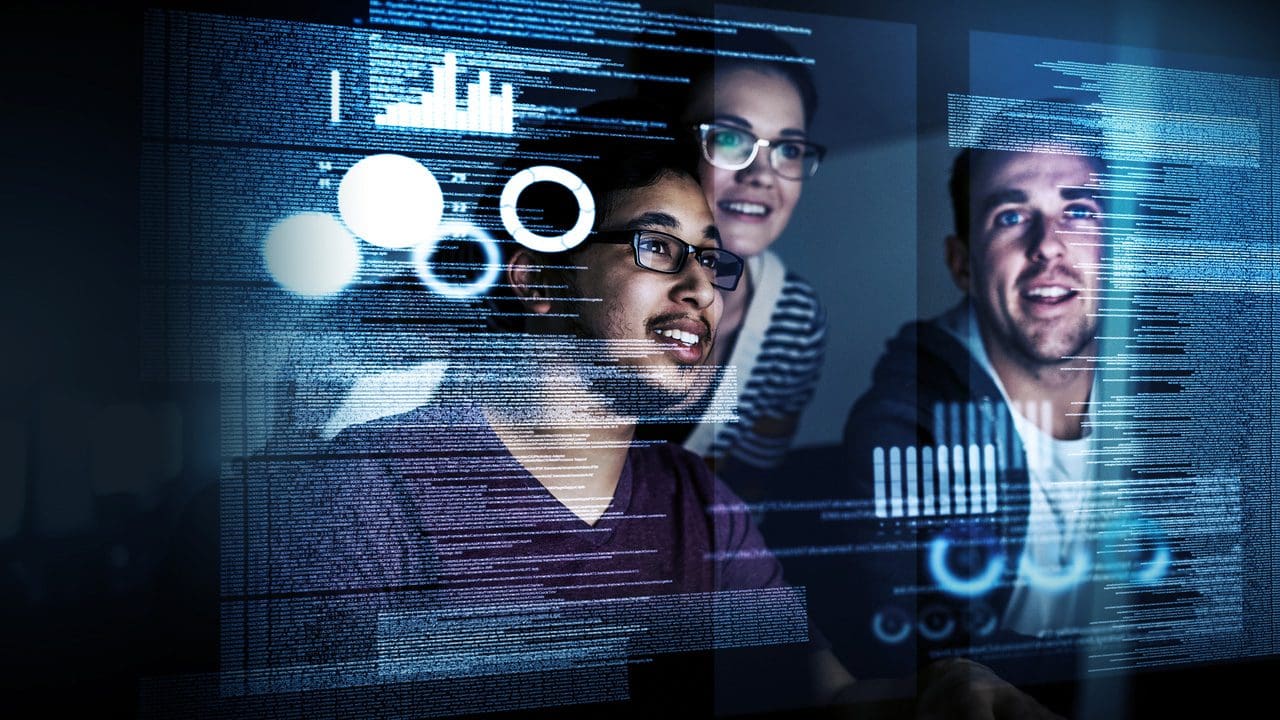 Three people coding together.