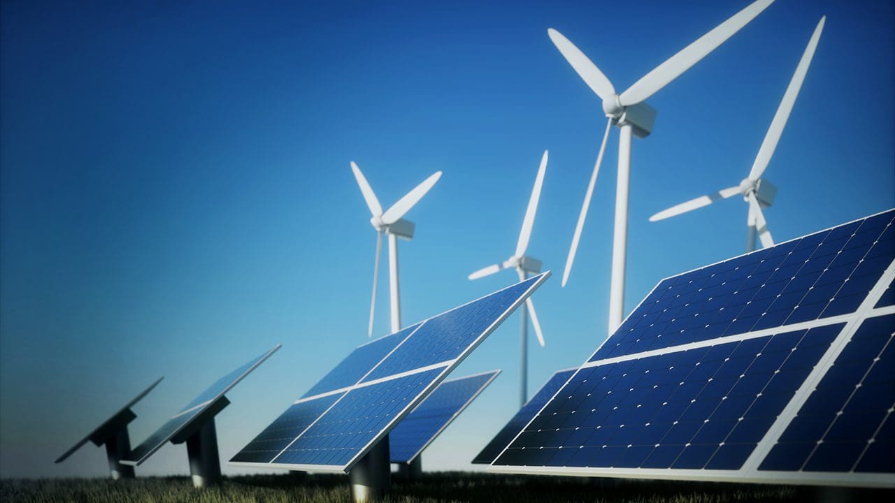 Solar panels and wind turbines against a blue sky.