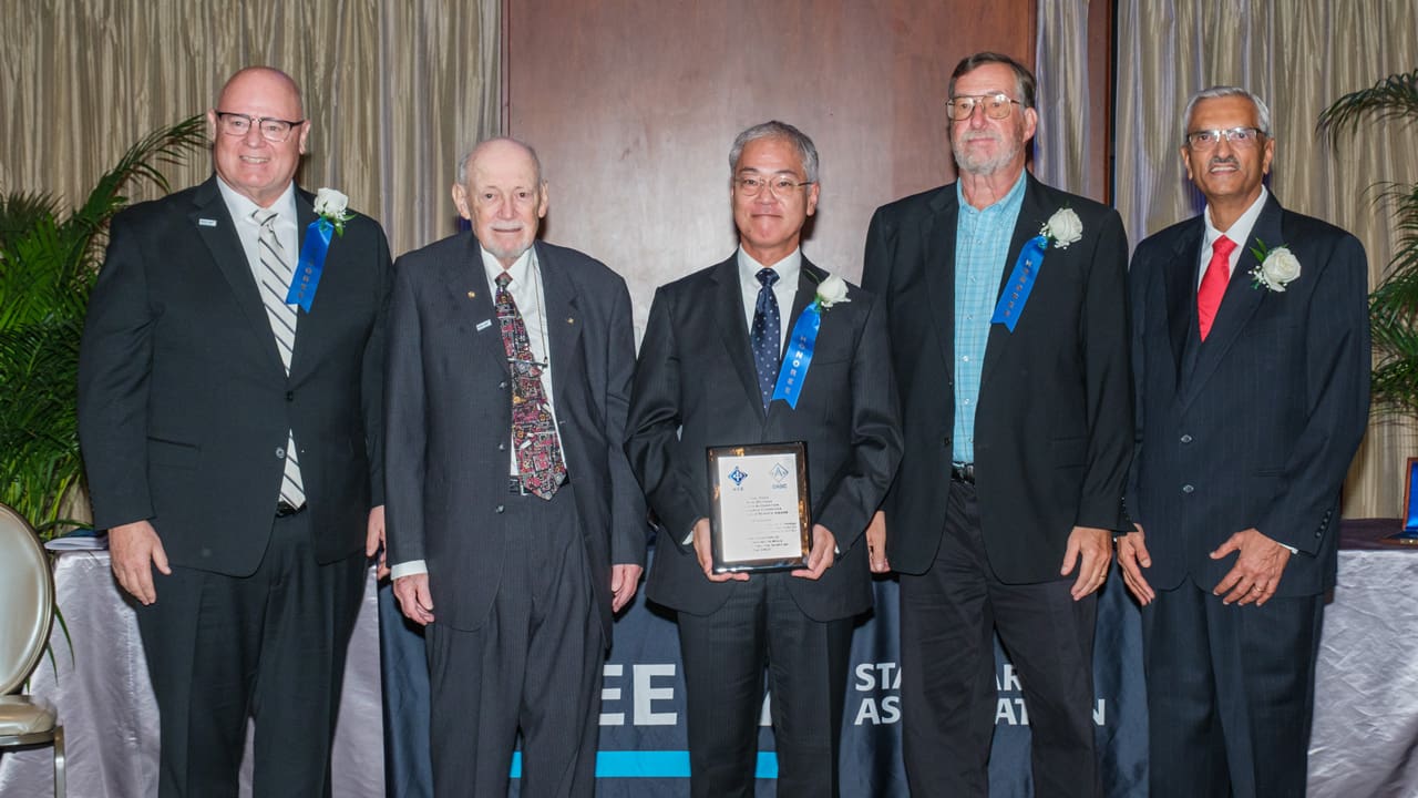 Recipient posing with award