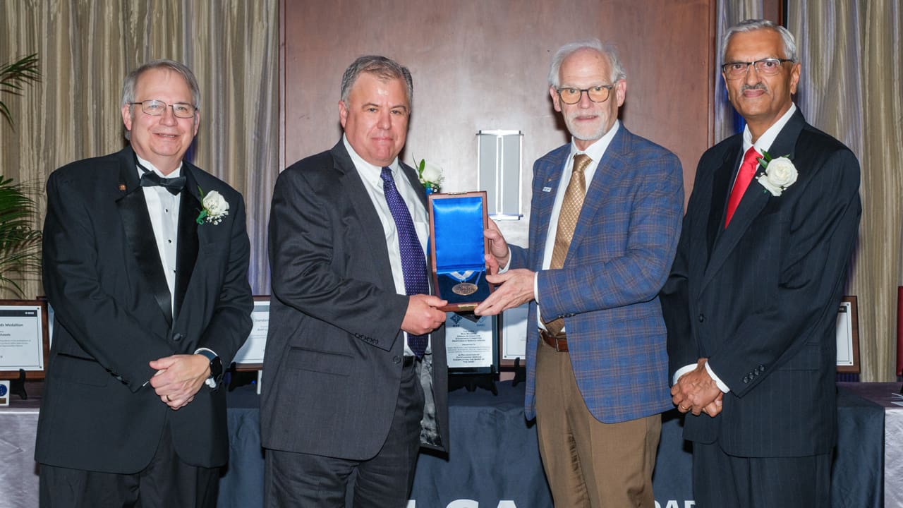 Recipient posing with award