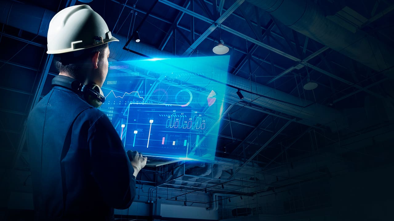 Image of a construction worker using technology at a construction site.