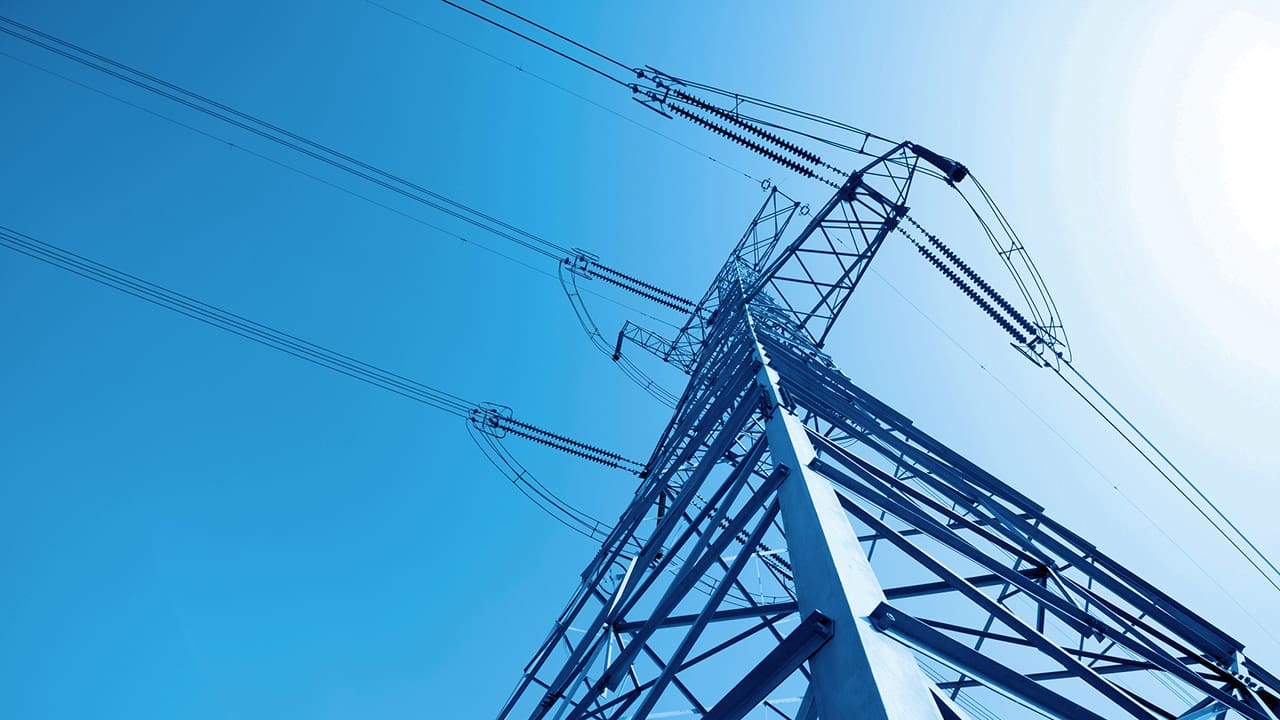 Looking up at the top of an energy transmission tower.